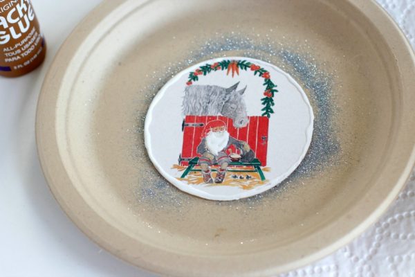 Adding Glue to Vintage Coasters Turned Glitter Ornaments