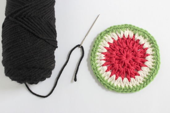 Adding black yarn for watermelon seeds