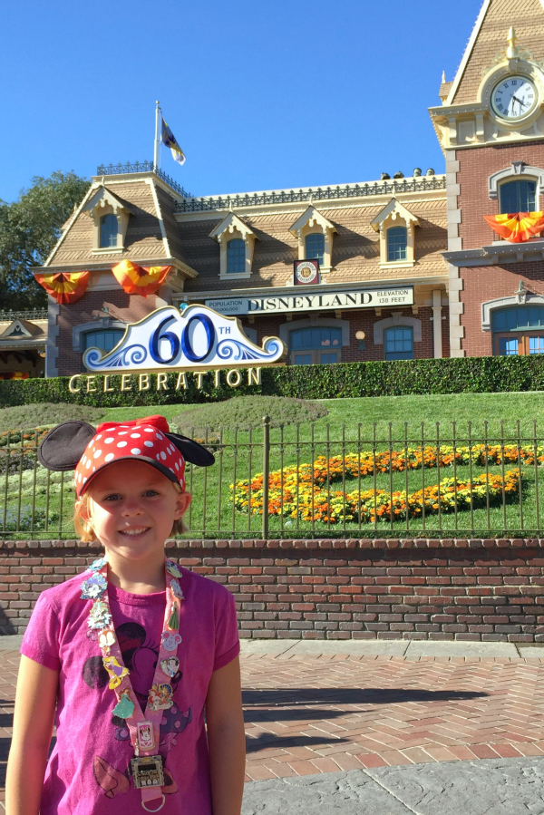 Decked out Disneyland with Disney outfits and Disney pins
