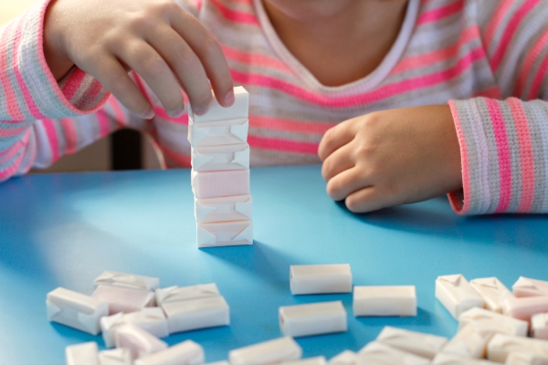 Kids Play Stack em' Up Game with Candy