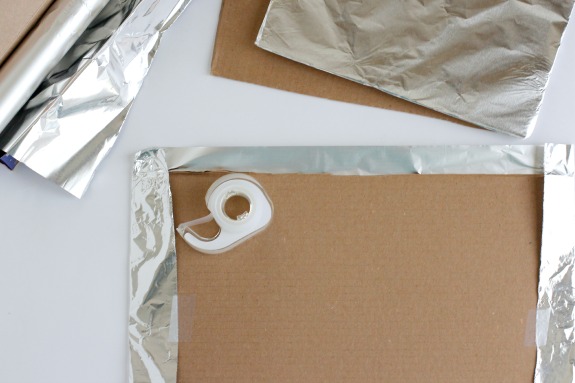 Wrapping tinfoil over cardboard to make candy houses