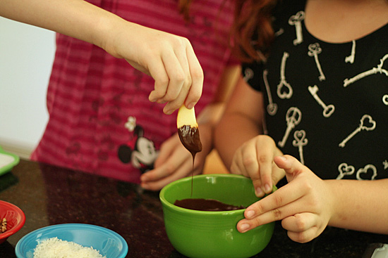Dipping apple slices in chocolate