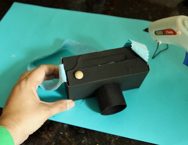 Cardboard play camera with strap and button