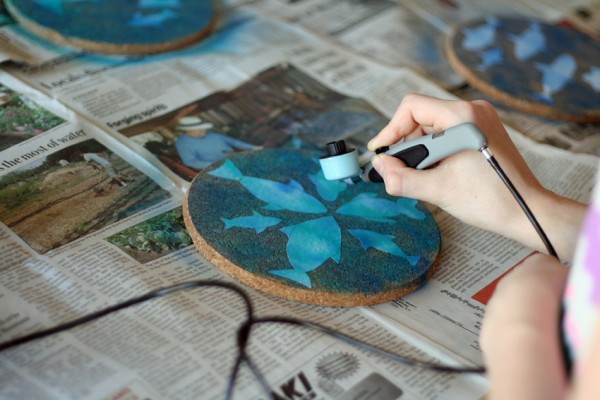 Airbrushing layers of color on coasters