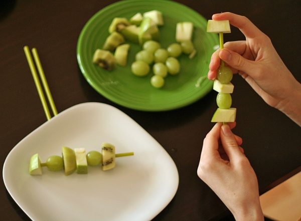 Making green fruit skewers with kids