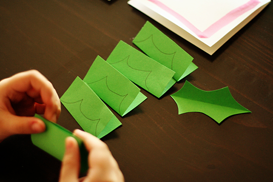 Cutting paper holly leaves