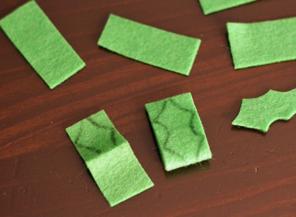 Cutting green felt holly leaves