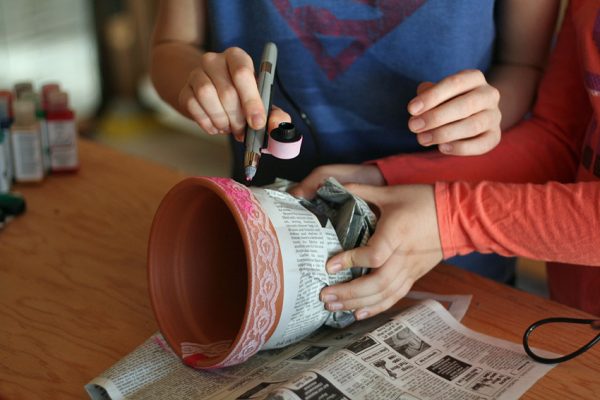 Lace ribbon stenciling on flower pots