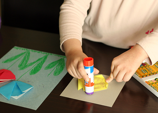 Glueing origami tulips to drawing