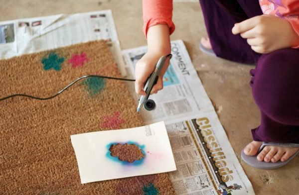 Airbrush painting on a doormat