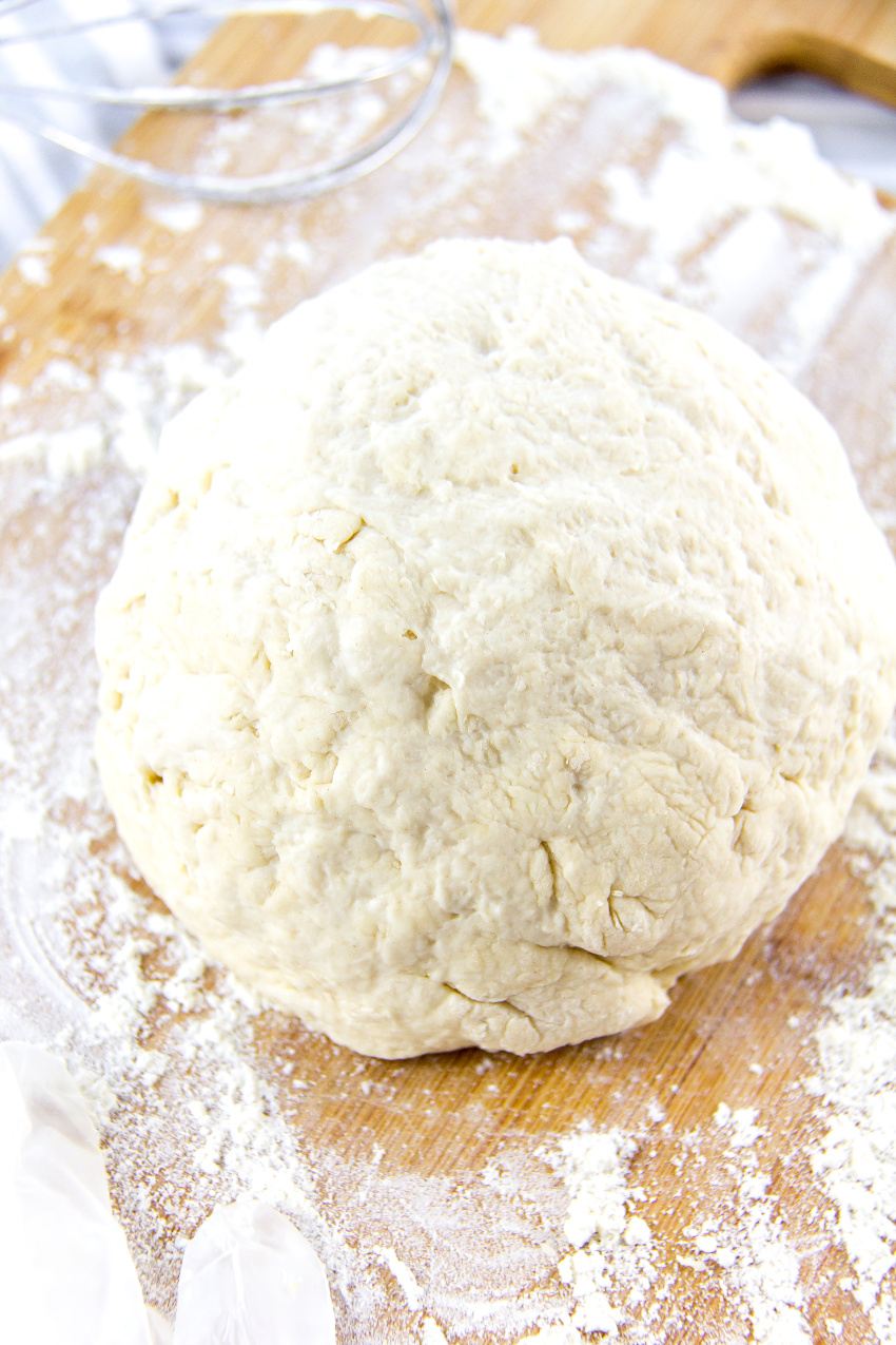 a ball of dough on a floured cutting board