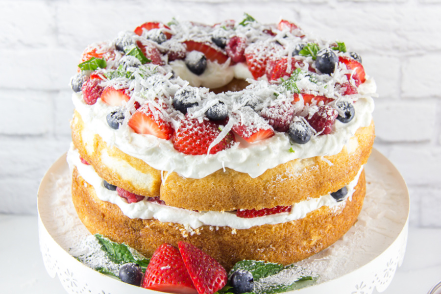 angel food cake decorated with berries and coconut for the 4th of July