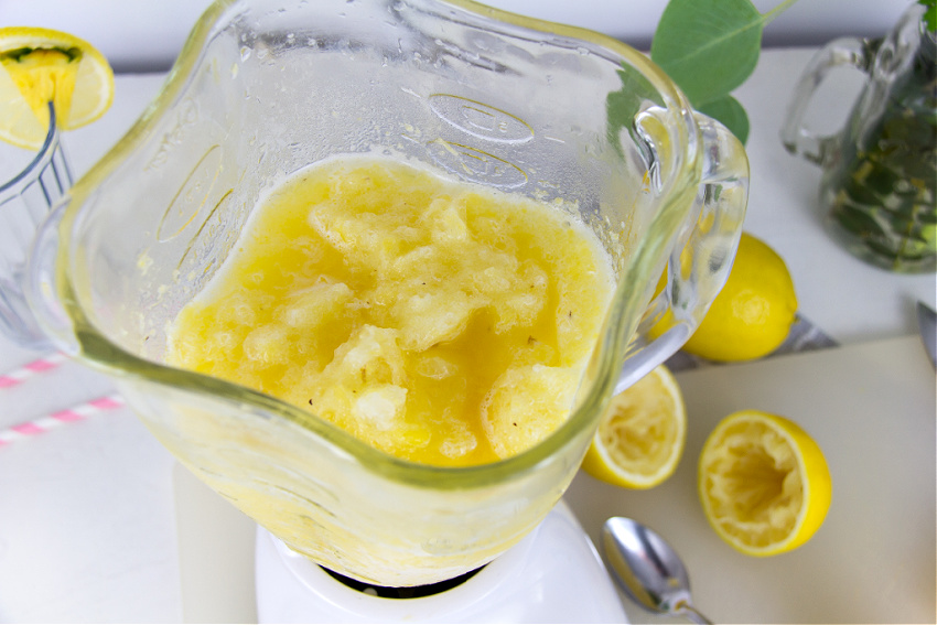 a pineapple and lemon slushy being made in a blender