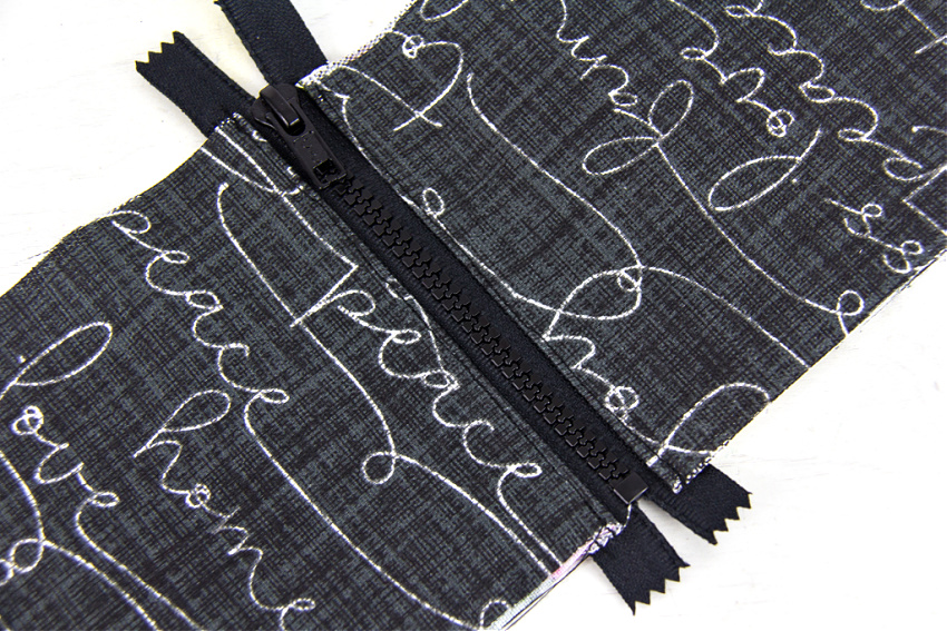 a black zip sewn between two pieces of fabric to make a bag