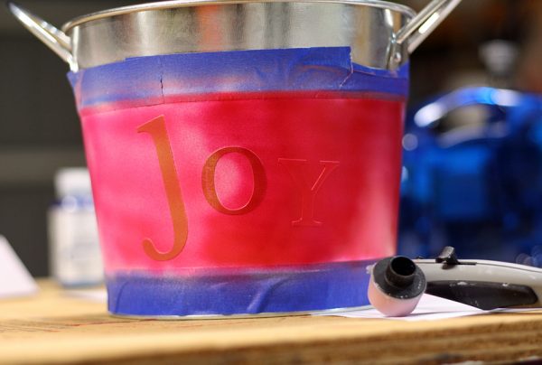 Airbrushing metal bucket with letter stickers