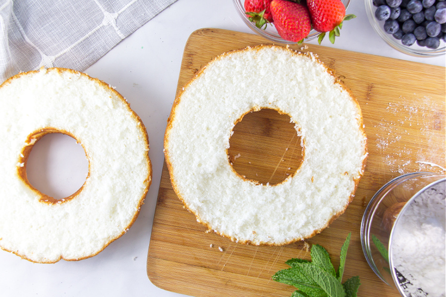 angel food cake sliced in half to fill with whipped cream and berries