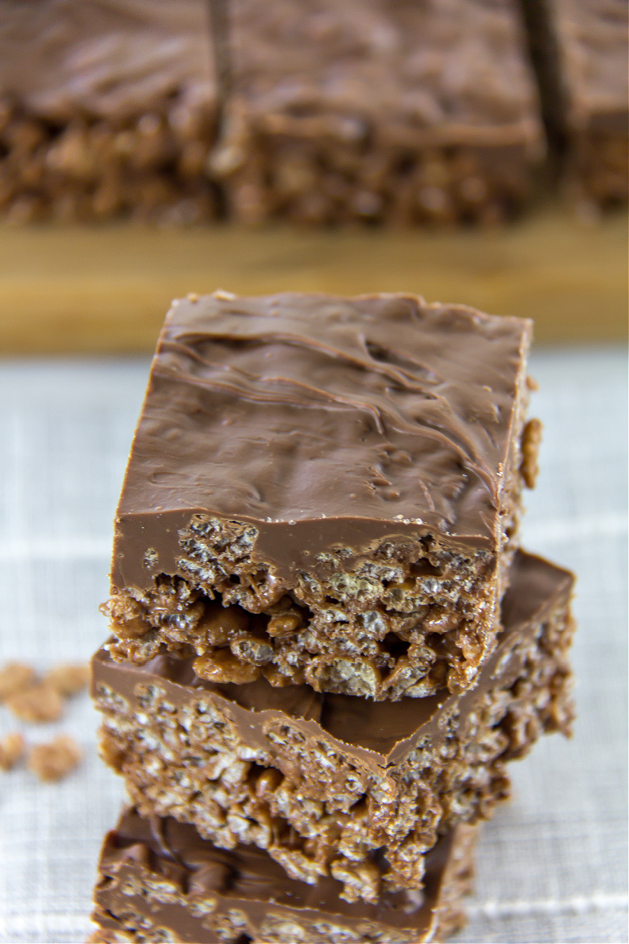 chocolate rice krispies squares with a layer of melted chocolate on top