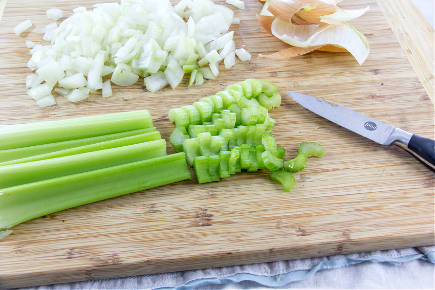 chopped onion and celery on a cutting board