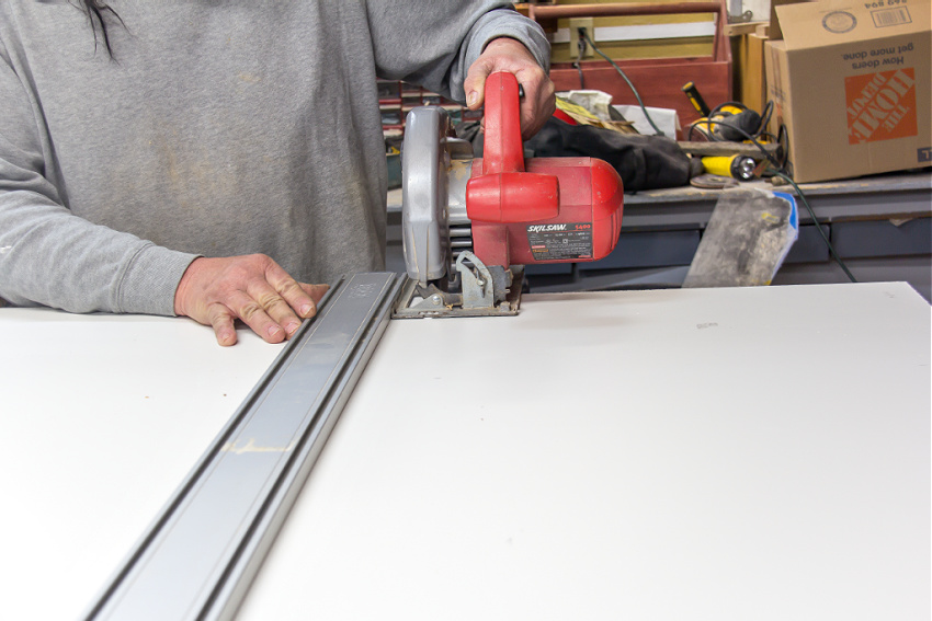 coated plywood being cut with a saw to make a box