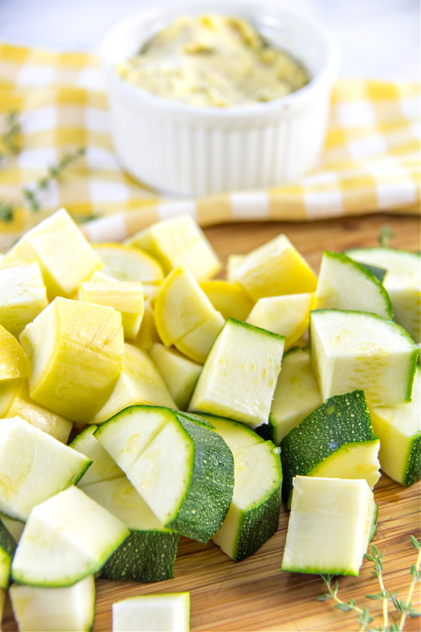 Diced zucchini and yellow squash on a cutting board