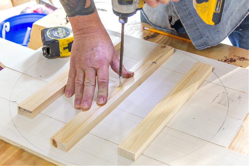 wood being screwed together to make a circle