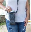 a lady wearing a white t-shirt and jeans with a black cross-body phone purse