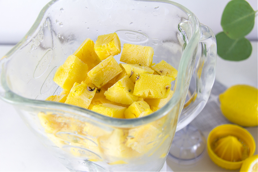 frozen pineapple chunks and ice in a blender