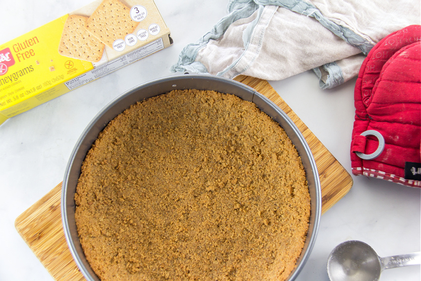 a gluten-free cheesecake crust inside a springform pan