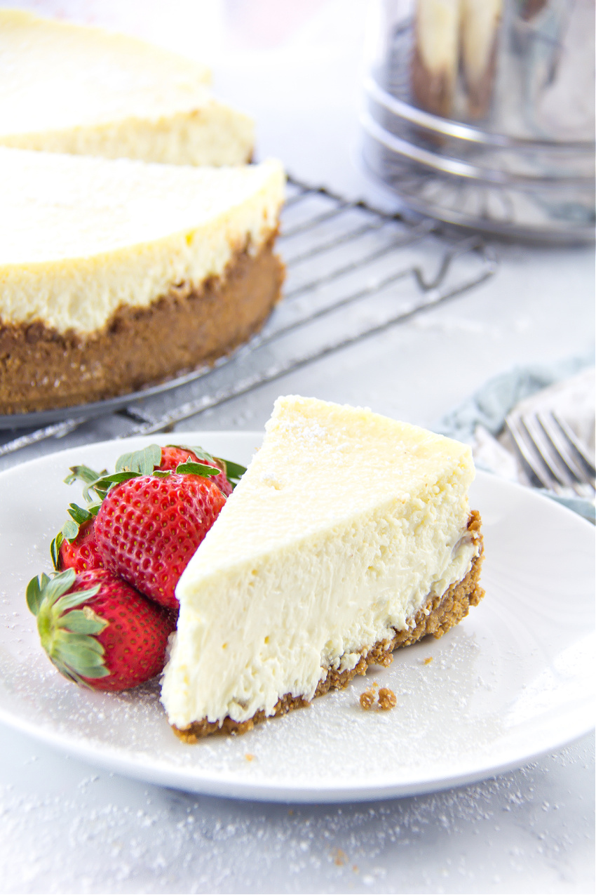 a slice of gluten-free cheesecake with strawberries on a white plate