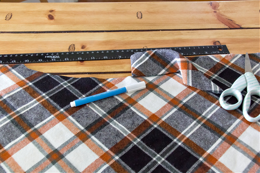a neckline being cut into a DIY poncho