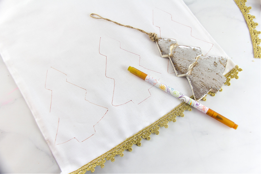 Christmas trees being drawn on a table runner