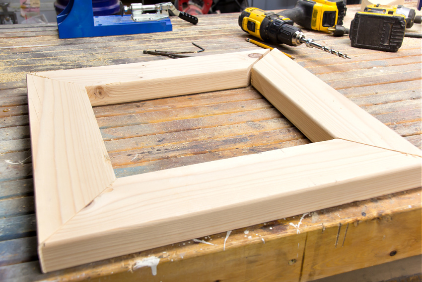 pine wood cut into four pieces that fit together like a picture frame