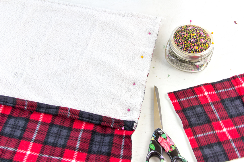 plaid fabric pinned to make a cushion cover