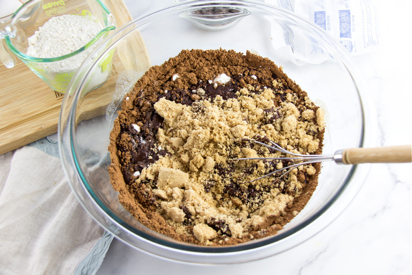 sugar being added to brownie batter