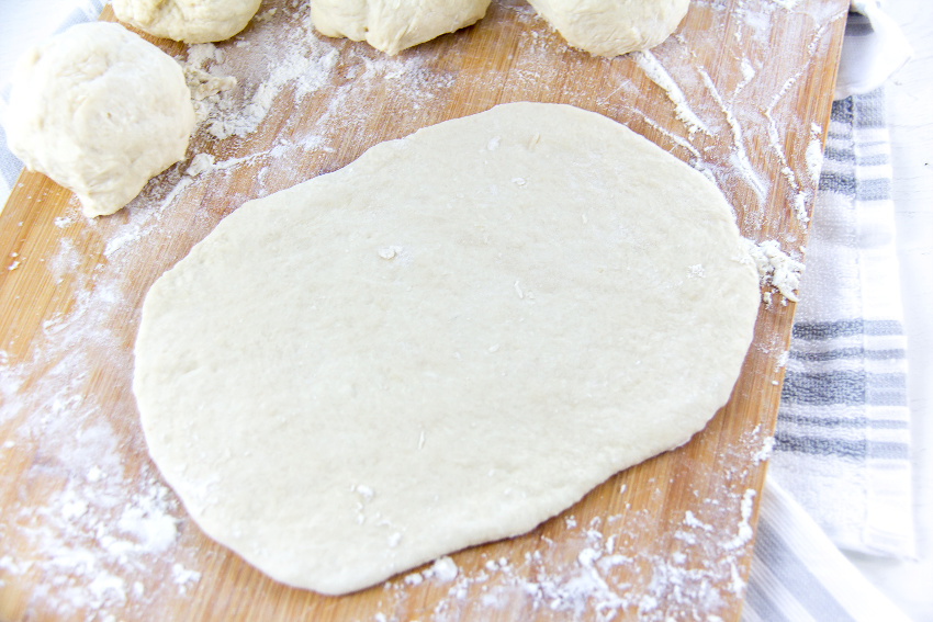 dough rolled out on floured surface to make flatbread
