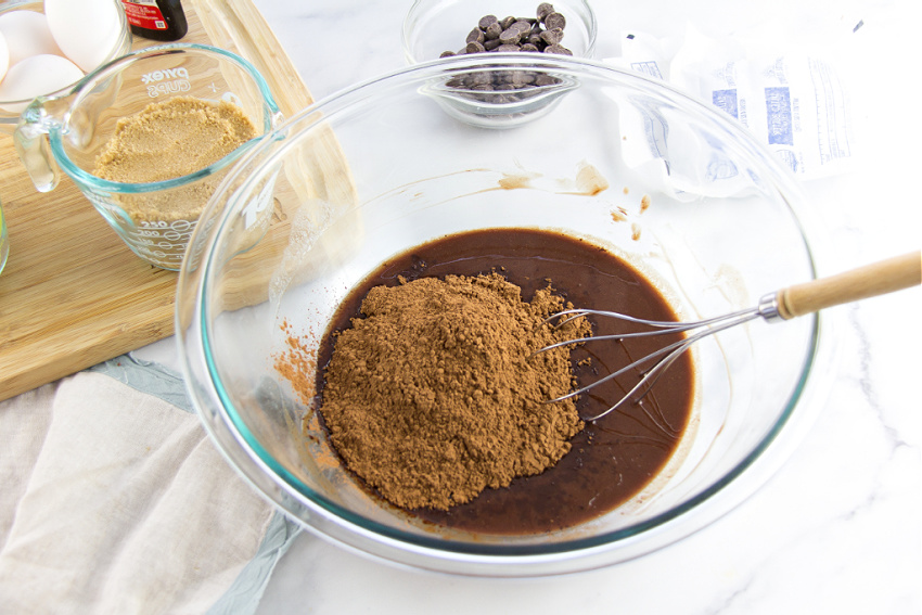 melted chocolate in a bowl with cocoa powder