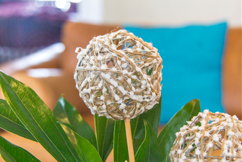 natural and white branch ball stem added to a winter flower arrangement