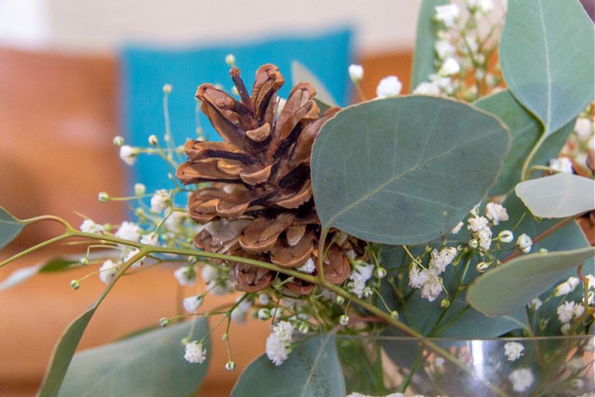 pinecone added to a winter flower arrangement