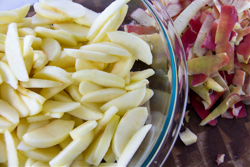 peeled and sliced pink lady apples in a bowl for making pie